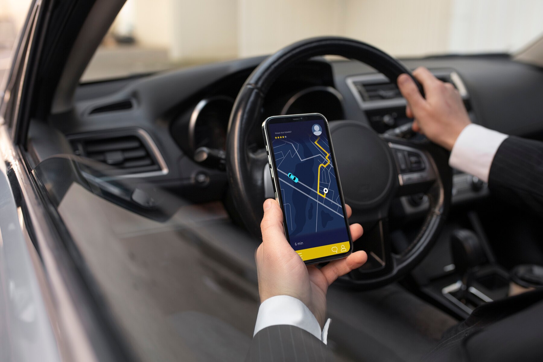 A Zenna driver holding a phone with the navigation route open